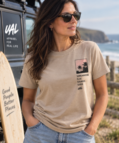 UAL Sunsets Bonfires & Good Vibes T-Shirt Woman wearing a beige UAL Sunsets Bonfires and Good Vibes graphic T-shirt