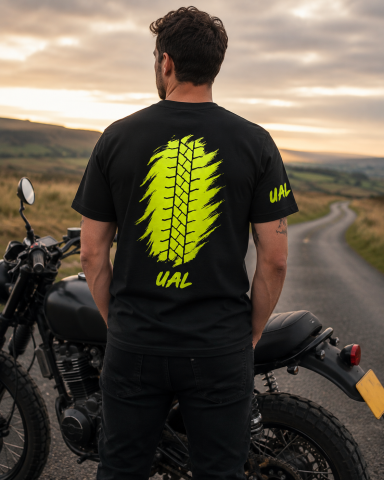 UAL Tyre Track T-Shirt – Black Man wearing black UAL T-shirt with bright tyre-track back graphic