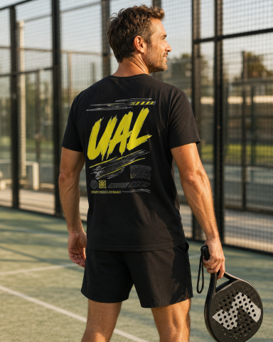UAL Padel Graphic T-Shirt – Black Man wearing black UAL graphic T-shirt on a padel court