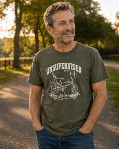 Unsupervised Raised on Two Wheels T-Shirt – Olive Man wearing olive Unsupervised bicycle graphic T-shirt
