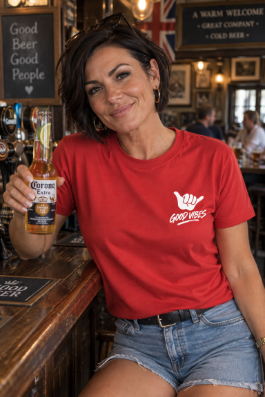 UAL Good Vibes T-Shirt – Red Woman wearing red UAL Good Vibes T-shirt in a British pub